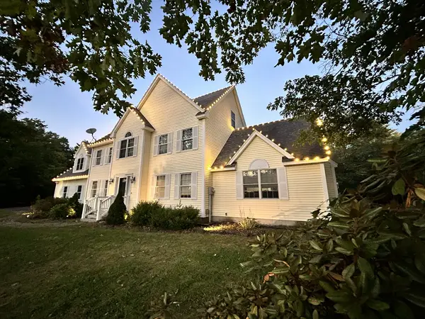 Warm white roofline lighting on a home in Barrington, NH