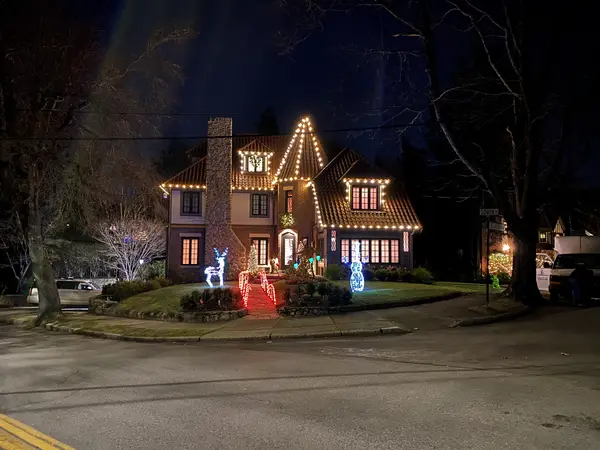 Roofline, bushes and walkway lit in Brookline, MA