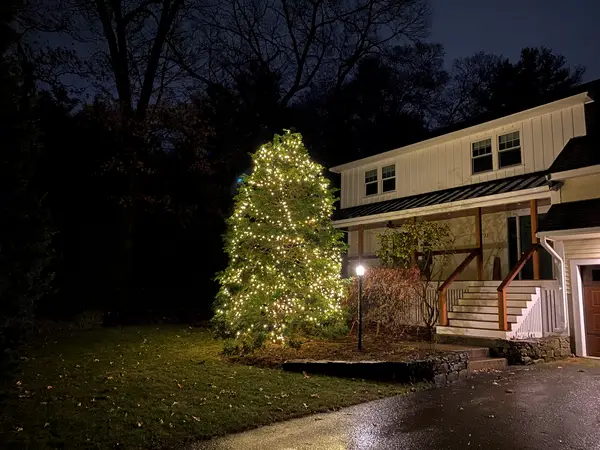 Warm white roofline lighting on a home in Burlington, MA