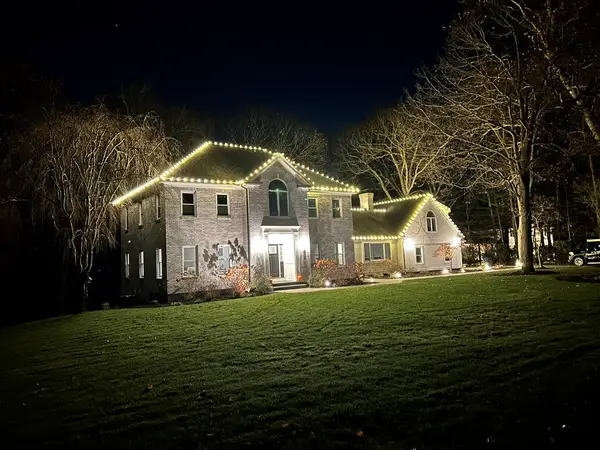 Roofline and landscape lighting on a home in Canton, MA