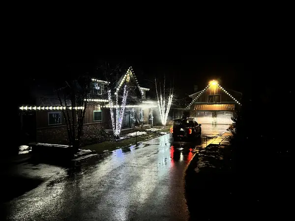 Warm white roofline lighting on a home in Carroll, NH