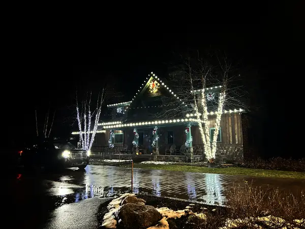 Roofline, bushes and walkway lit in Carroll, NH