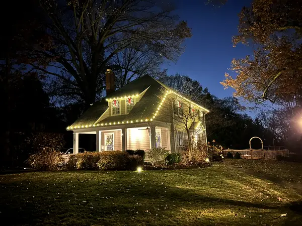 Warm white roofline lighting on a home in Glen Ridge, NJ
