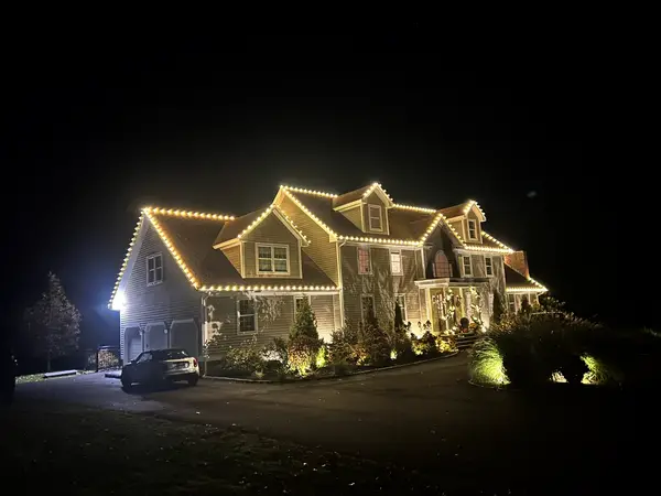 Warm white roofline lighting on a home in Killingworth, CT