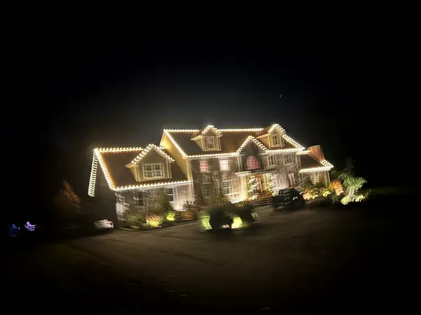 Roofline, bushes and walkway lit in Killingworth, CT