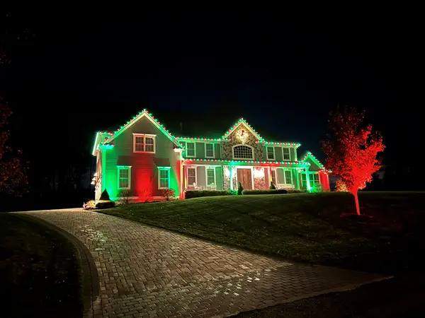 Roofline, bushes and walkway lit in Middleton, MA