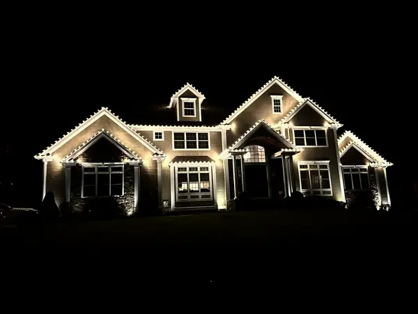 Warm white roofline lighting on a home in Middleton, MA