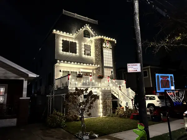 Warm white roofline lighting on a home in New York, NY