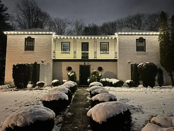 Warm white roofline lighting on a home in Orange, NJ