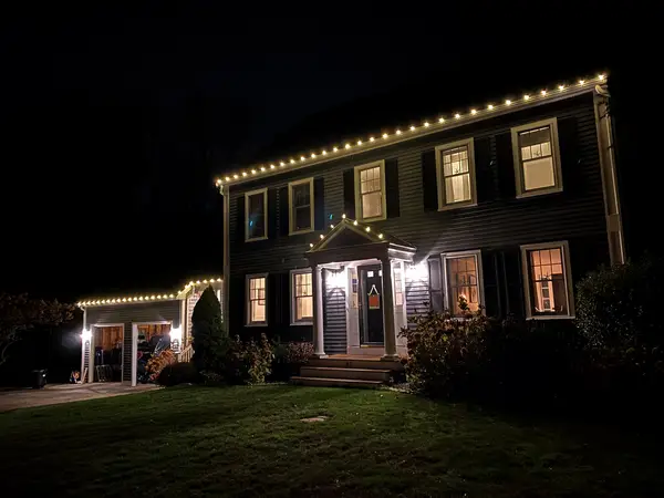 Roofline, bushes and walkway lit in Scituate, MA