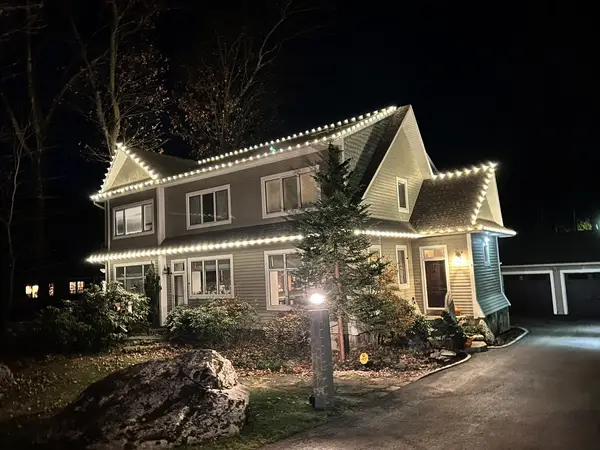 Warm white roofline lighting on a home in Shrewsbury, MA