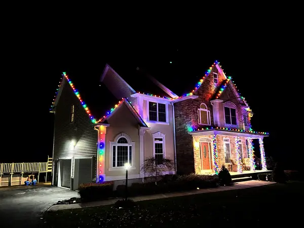 Roofline, bushes and walkway lit in Town of Fishkill, NY