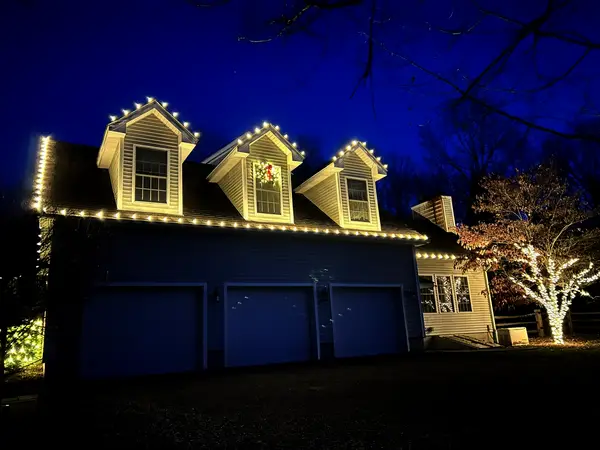 Warm white roofline lighting on a home in Town of Red Hook, NY