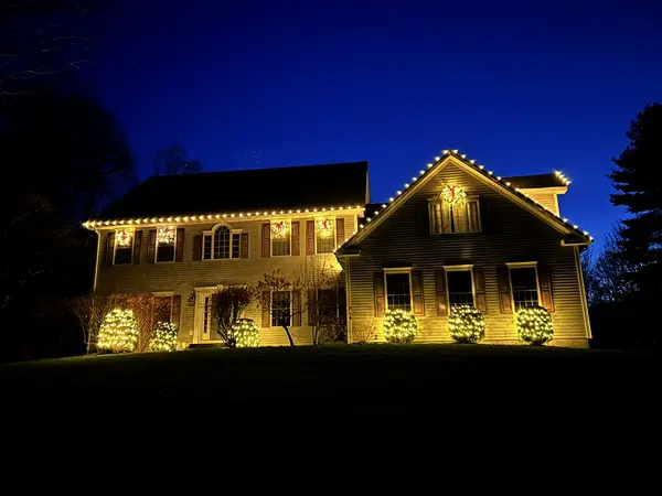 Roofline, bushes and walkway lit in Town of Red Hook, NY