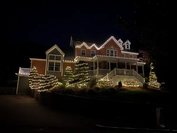 Warm white roofline lighting on a home in Wakefield, MA