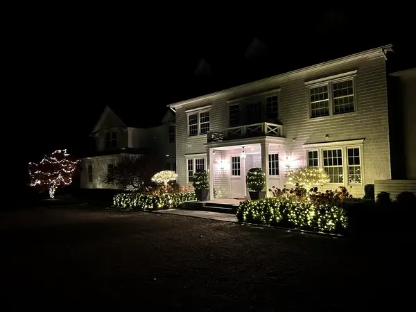 Warm white roofline lighting on a home in Washington, CT