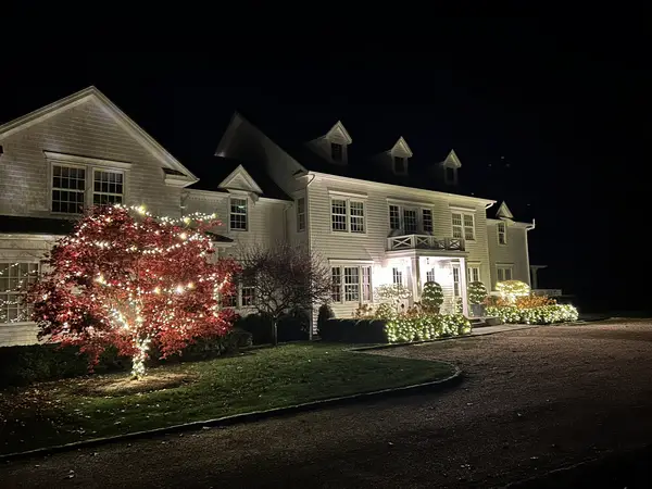Roofline, bushes and walkway lit in Washington, CT