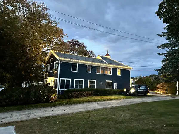 Warm white roofline lighting on a home in Waterford, CT
