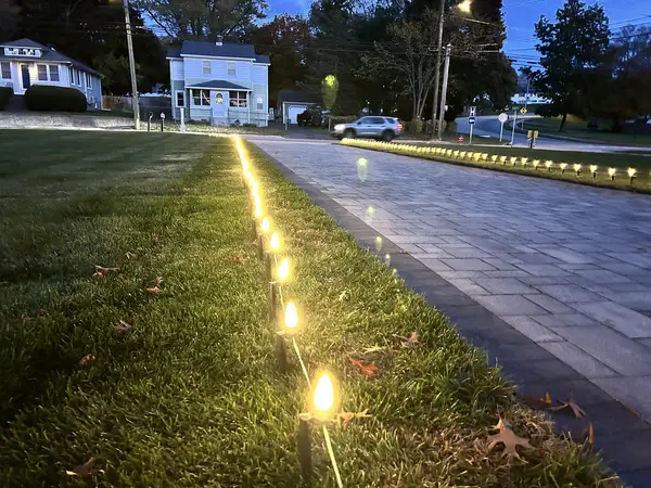 Roofline, bushes and walkway lit in Waterford, CT
