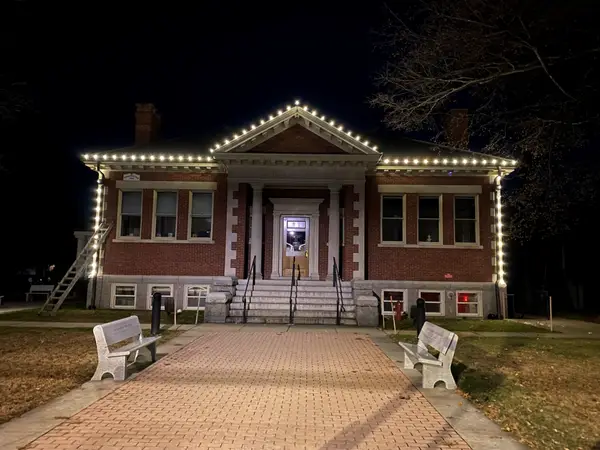 Municipal holiday lighting on a town center building installed by the Holiday Lights Decor network